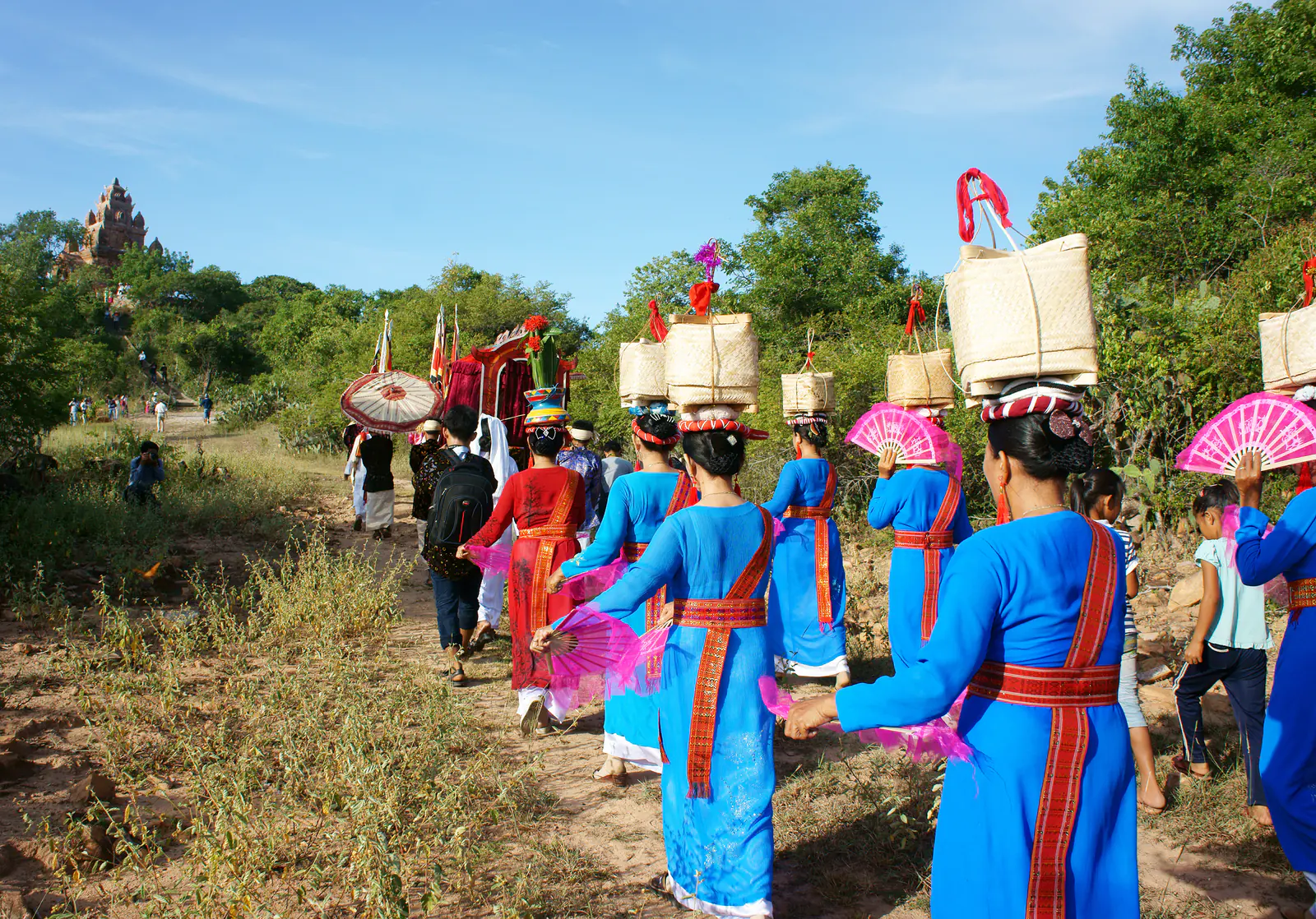 Cham Community Procession Cham women in traditional dress walking in a community procession